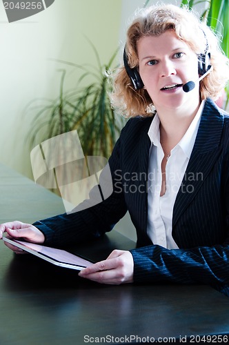 Image of Business woman with digital tablet PC and headset