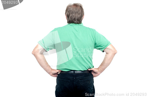 Image of Back pose of elderly guy with hands on his waist