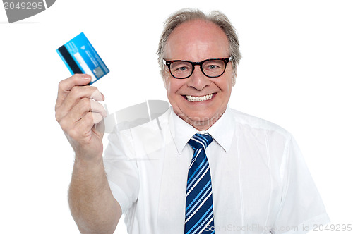 Image of Cheerful aged employer holding up a cash card