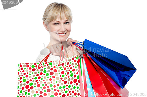 Image of Pretty female carrying shopping bags over shoulders
