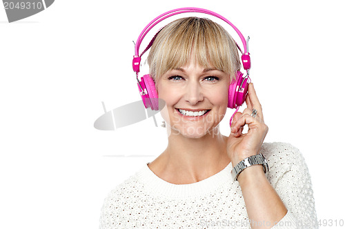 Image of Portrait of a cheerful woman with headphones on