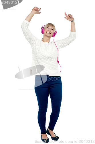 Image of Joyous middle aged woman dancing to the beat