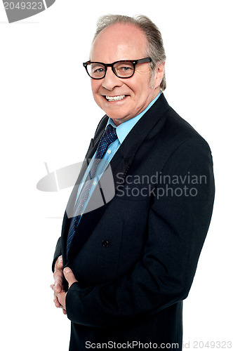 Image of Bespectacled businessman posing sideways