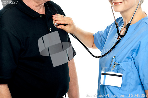 Image of Cropped image of doctor examining a patient