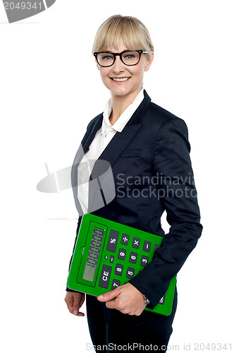 Image of Confident corporate woman holding calculator