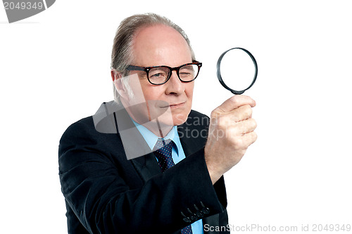 Image of Detective  exploring through a magnifying glass