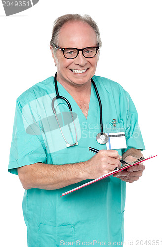 Image of Cheerful doctor gathering information from patient