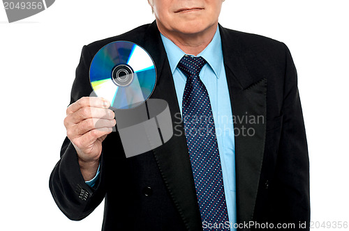 Image of Cropped image of a male showing compact disk