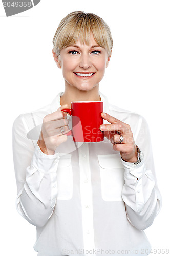 Image of Female manager posing with coffee mug in hand