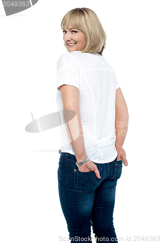 Image of Smartly dressed woman with hands in back pocket of jeans