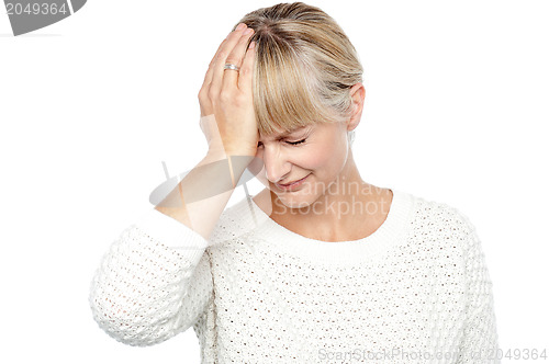 Image of Sad middle aged woman suffering from headache