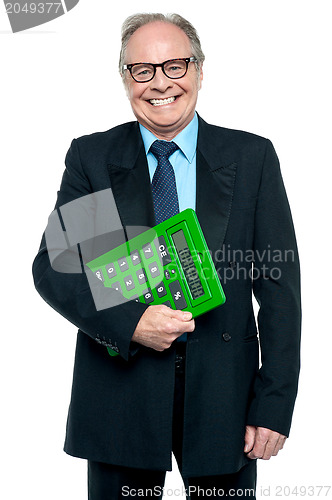 Image of Senior male manager holding big green calculator