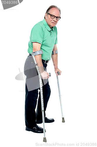 Image of Physically disabled old man with crutches