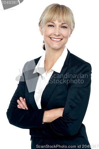 Image of Smiling corporate head posing with folded arms