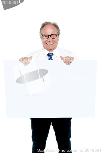 Image of Senior marketing manager holding up a blank ad board