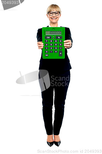 Image of Woman in business suit displaying large green calculator