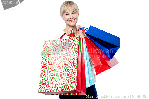 Image of Vivacious woman holding colorful shopping bags