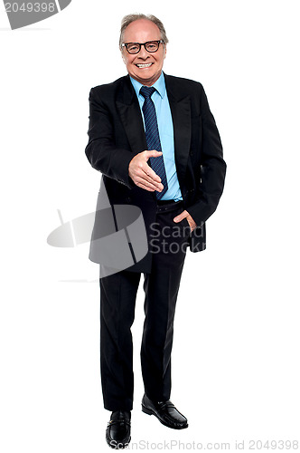 Image of Joyous businessman extending his hand