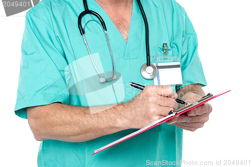 Image of Medical expert jotting down case sheet notes