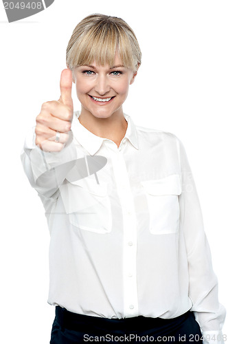 Image of Successful businesswoman showing thumbs up