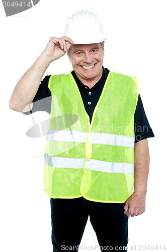 Image of Matured construction worker holding his safety helmet