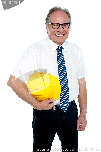 Image of Smiling experienced architect posing with safety helmet