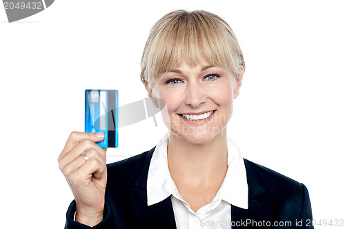 Image of Joyous female employee showing credit card