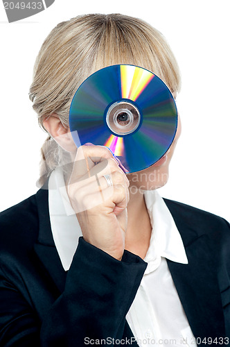 Image of Corporate lady looking through compact disc hole