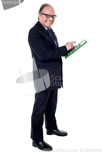 Image of Cheerful senior businessman using a calculator