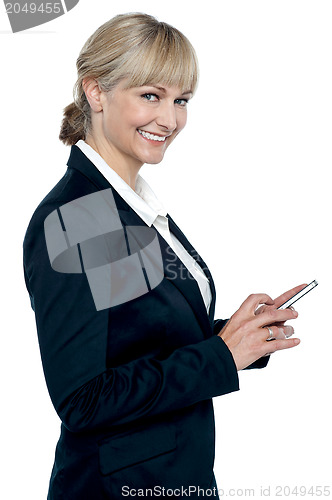 Image of Female executive operating touch screen cellphone