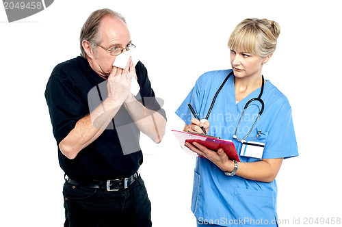 Image of Aged male suffering from cold, sneezing