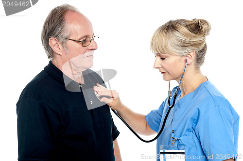 Image of Female doctor examining an elderly man