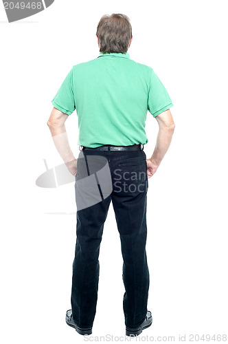 Image of Back pose of a senior man looking at the wall