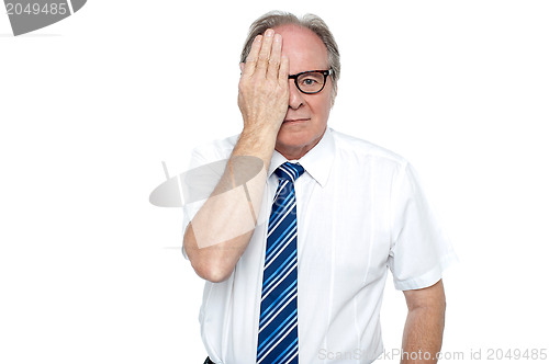Image of Manager with hand on right eye looking at you