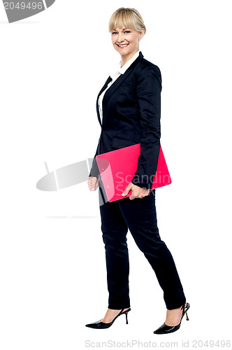 Image of Energetic employee walking with her clipboard