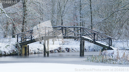 Image of Wooden bridge covered in snow