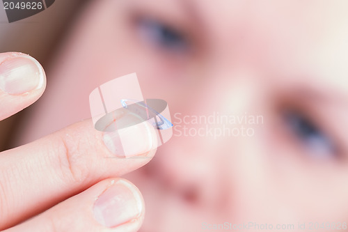 Image of Close up of inserting a contact lens