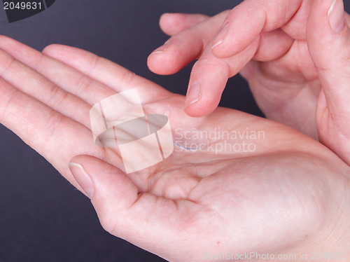 Image of Woman holds a Contact Lens