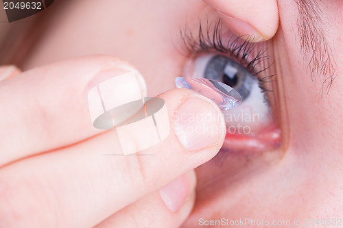 Image of Close up of inserting a contact lens