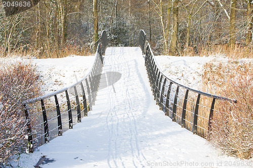 Image of Metal bridge covered in snow