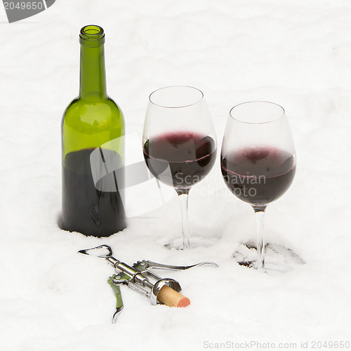 Image of Bottle of red wine and wineglasses isolated