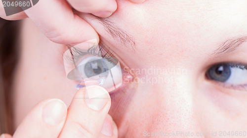 Image of Close up of inserting a contact lens