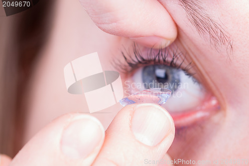 Image of Close up of inserting a contact lens