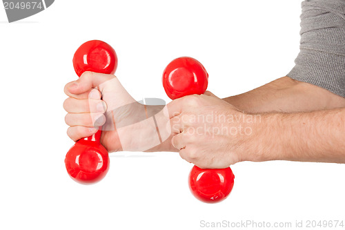 Image of Red dumbbells in the hands of a man, isolated