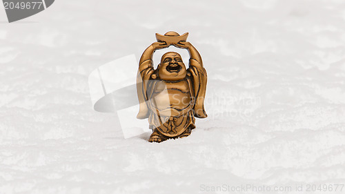 Image of Small happy Buddha standing in the snow