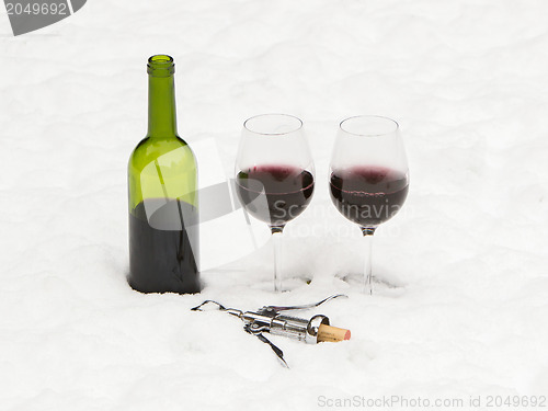 Image of Bottle of red wine and wineglasses isolated