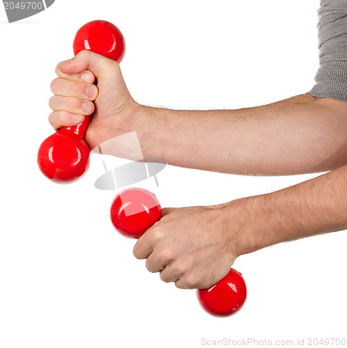 Image of Red dumbbells in the hands of a man, isolated