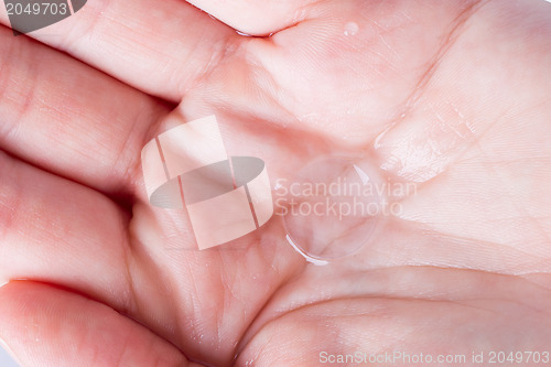 Image of Woman holds a Contact Lens