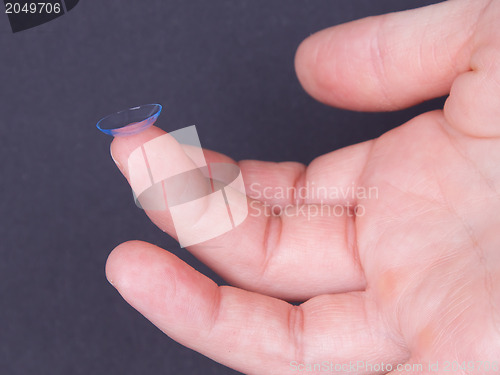 Image of Woman holds a Contact Lens