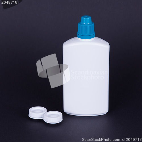 Image of Lens casing and bottle of water isolated on black